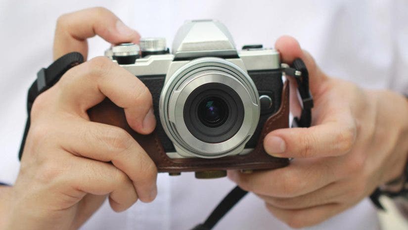 Man holding a mirrorless camera