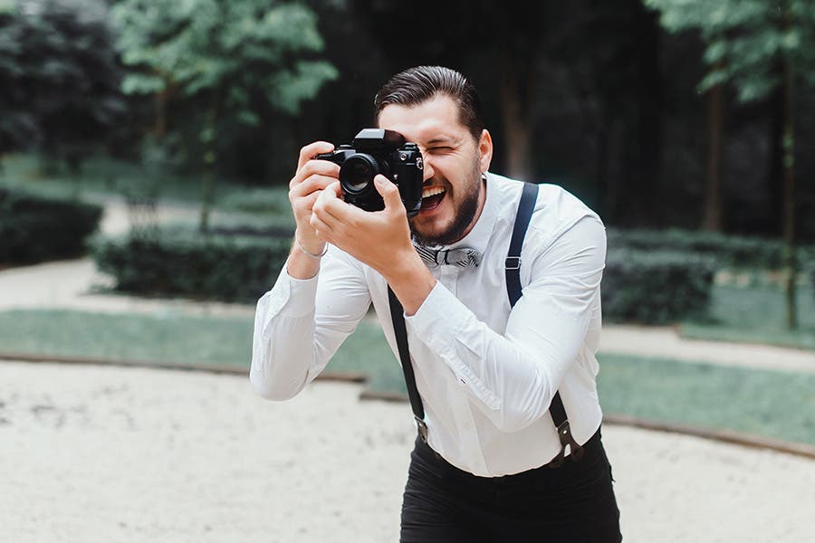 guest shooting a video at a wedding