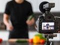 video camera filming a food blogger in a kitchen