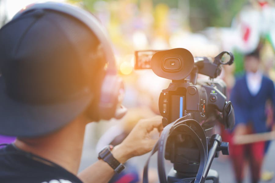 professional videographer covering an event with a videocam