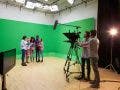 actors being filmed against a green screen in a studio