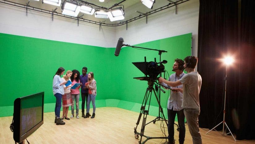 actors being filmed against a green screen in a studio