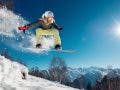 snowboarder jumping on mountain action photography