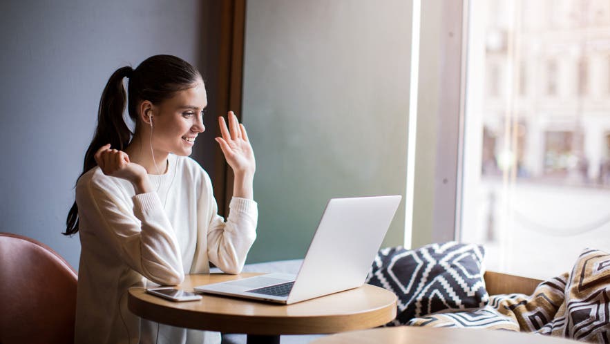woman video calling laptop