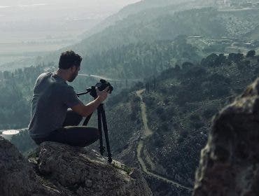 best travel tripods photographer doing landscape photography