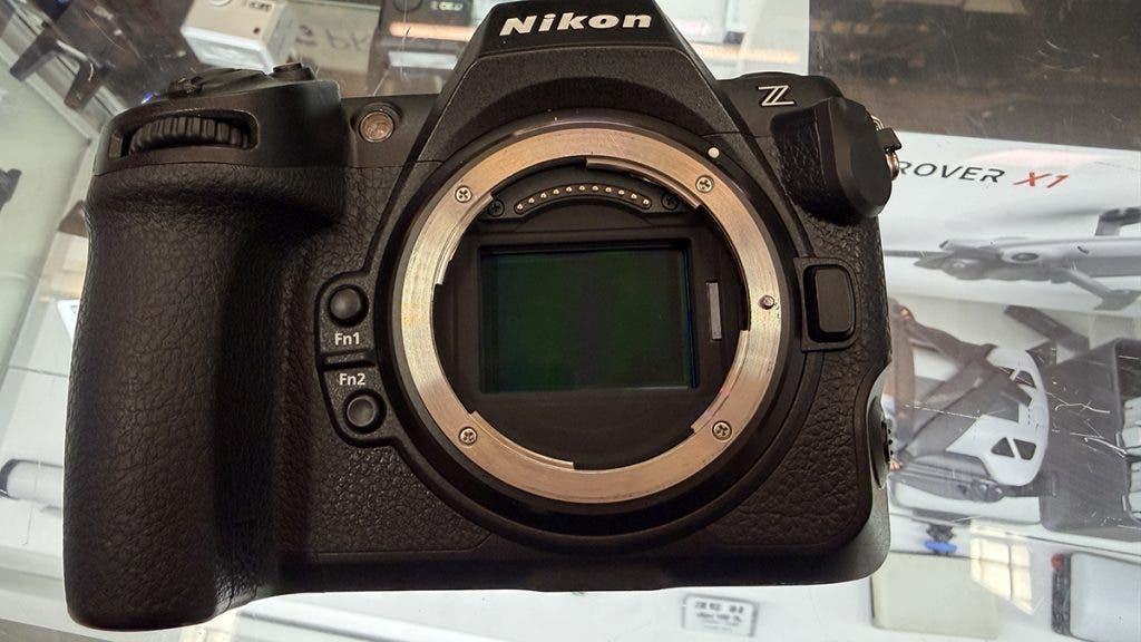 Direct close-up of a black Nikon Z series mirrorless camera body, showing a wide, open lens mount that exposes its large, rectangular full-frame camera sensor size.