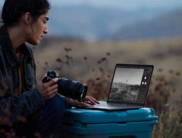 photographer with apple macbook pro with new apple m1 chip