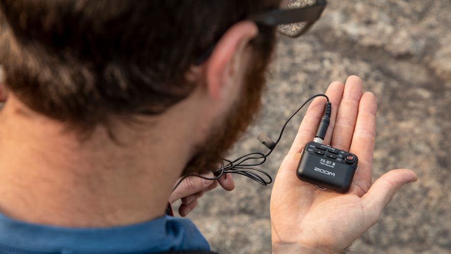 Zoom F2 Field Recorder in hand outdoor adventure audio recordings
