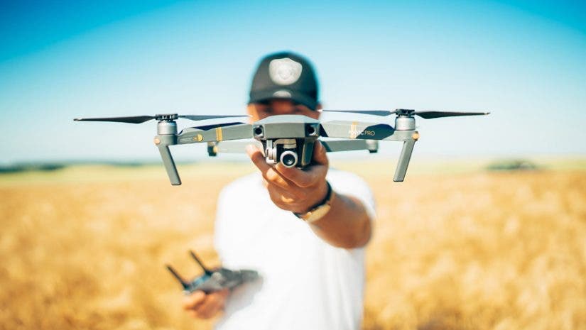 drone etiquette tips drone pilot with drone outdoors landscape