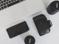 macbook laptop and canon camera and lenses on desk branding tips for creative businesses