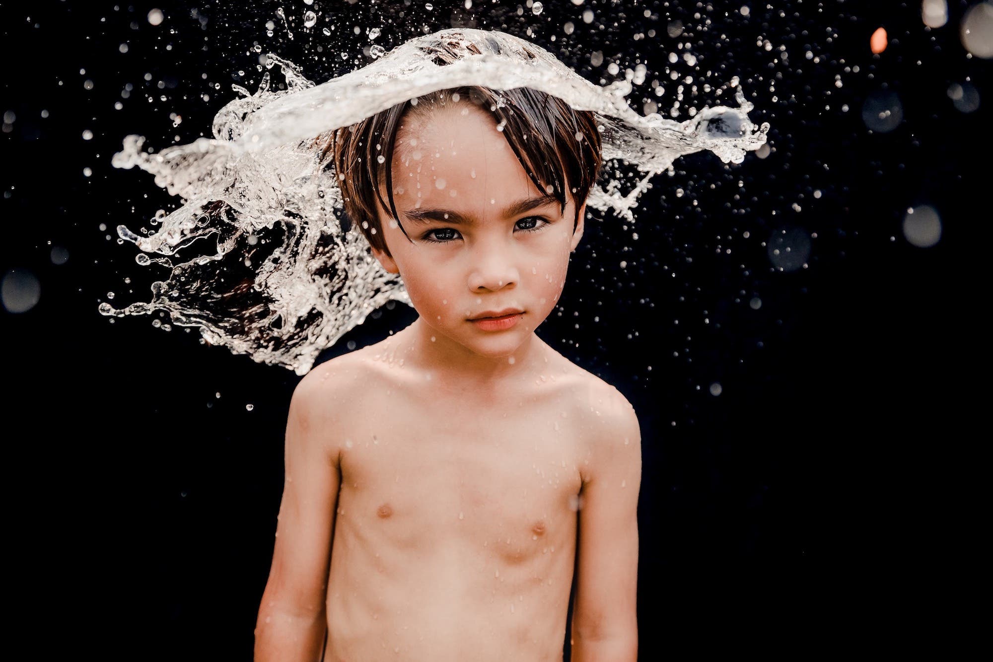water splashing on a kid's head