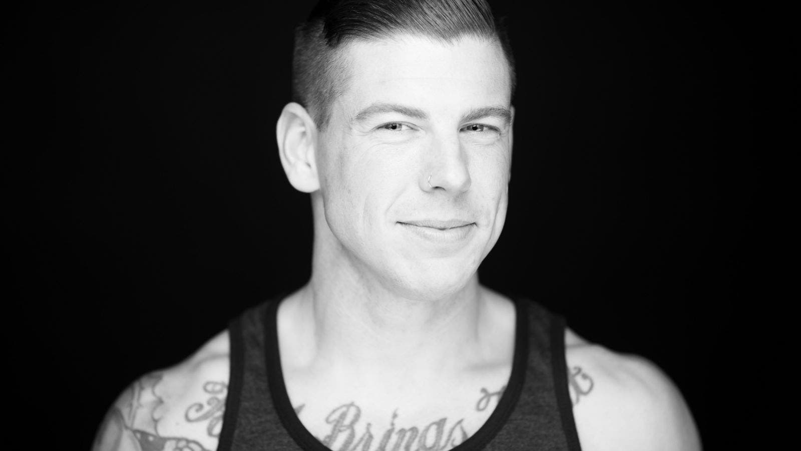 Male model poses for headshot while smiling