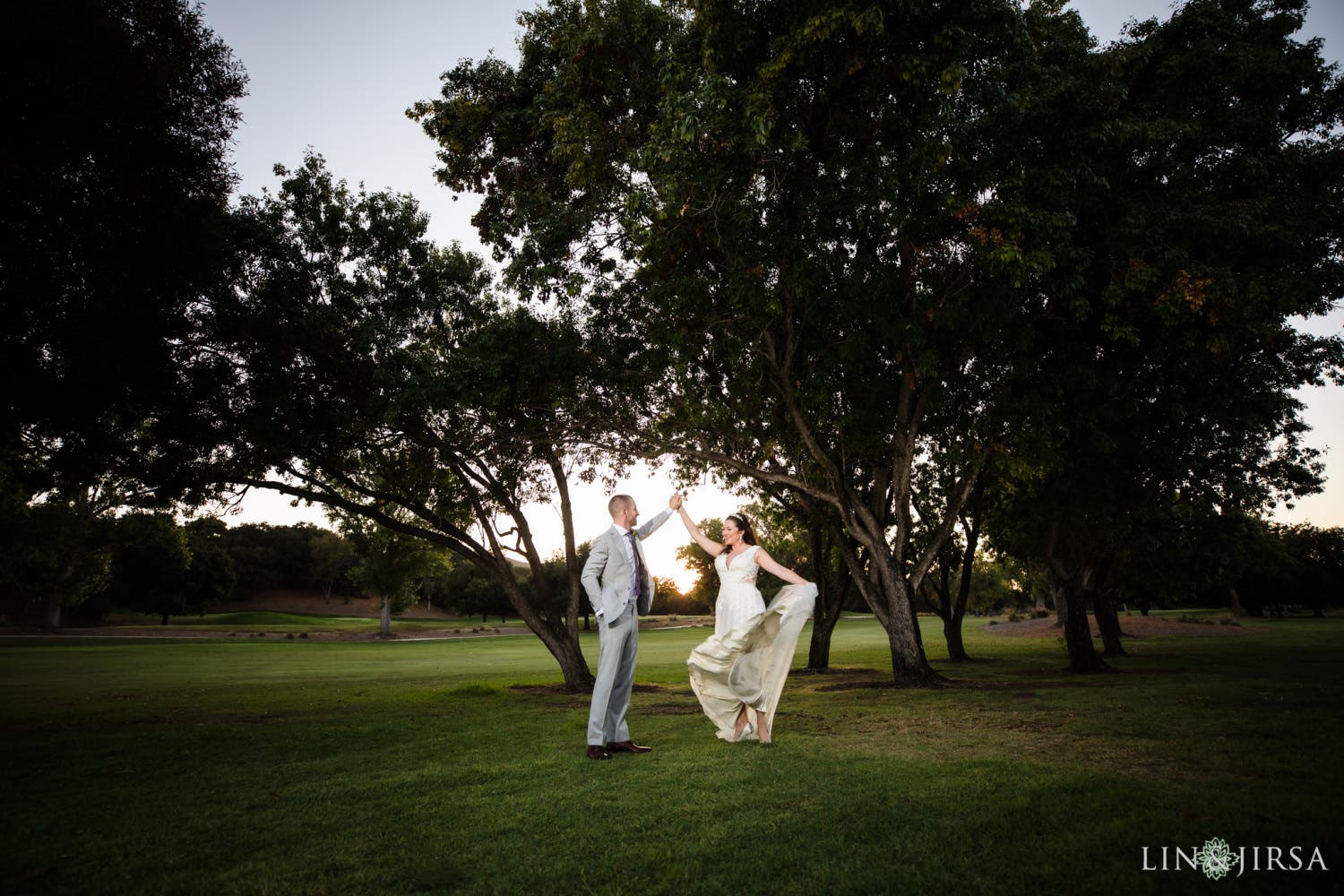 Couple twirls on a golf course