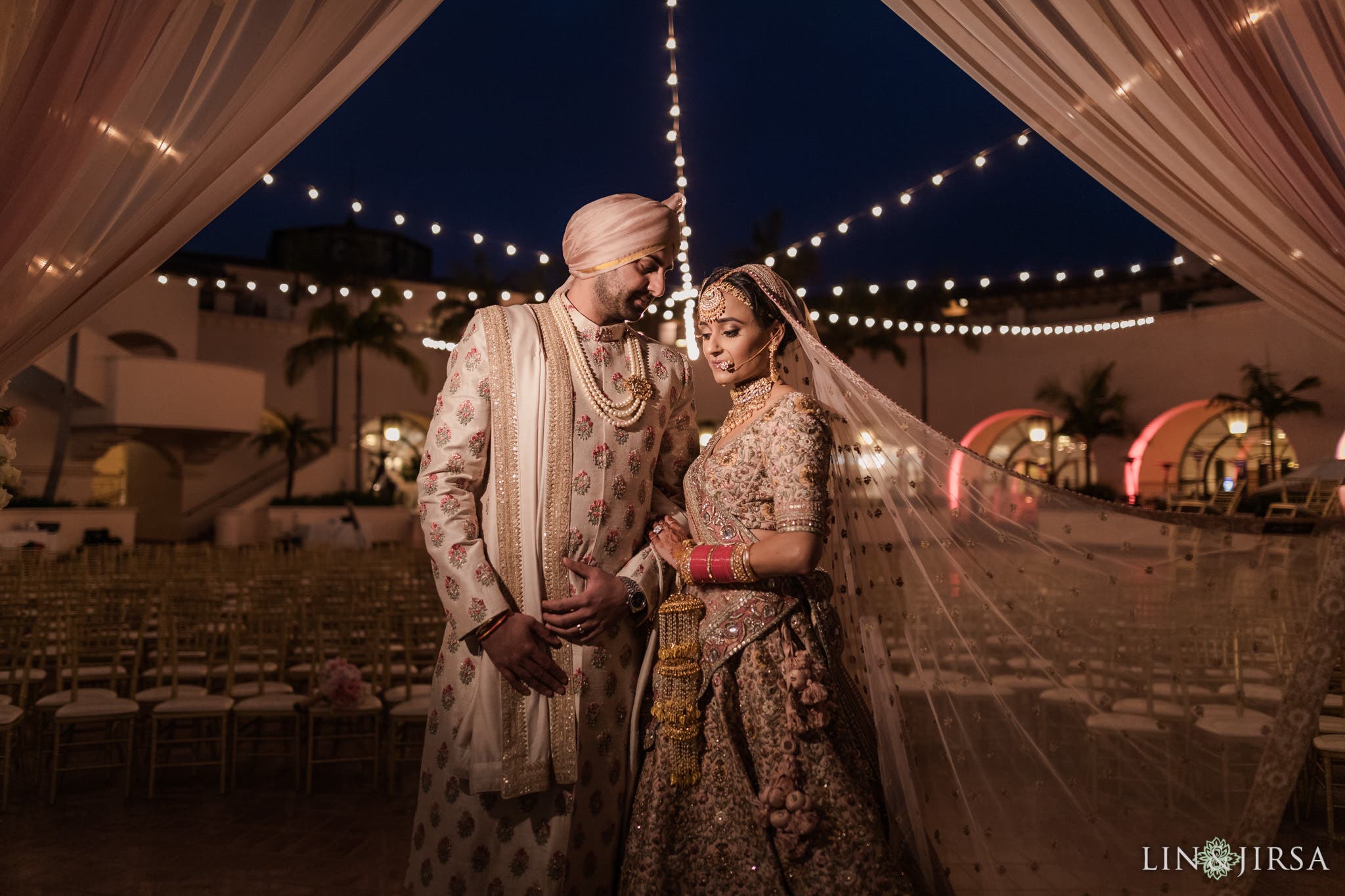 Wedded couple stands in v-up pose