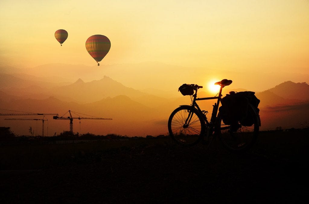 landscape with hot air balloons and asymmetrical bicycle balance in photography