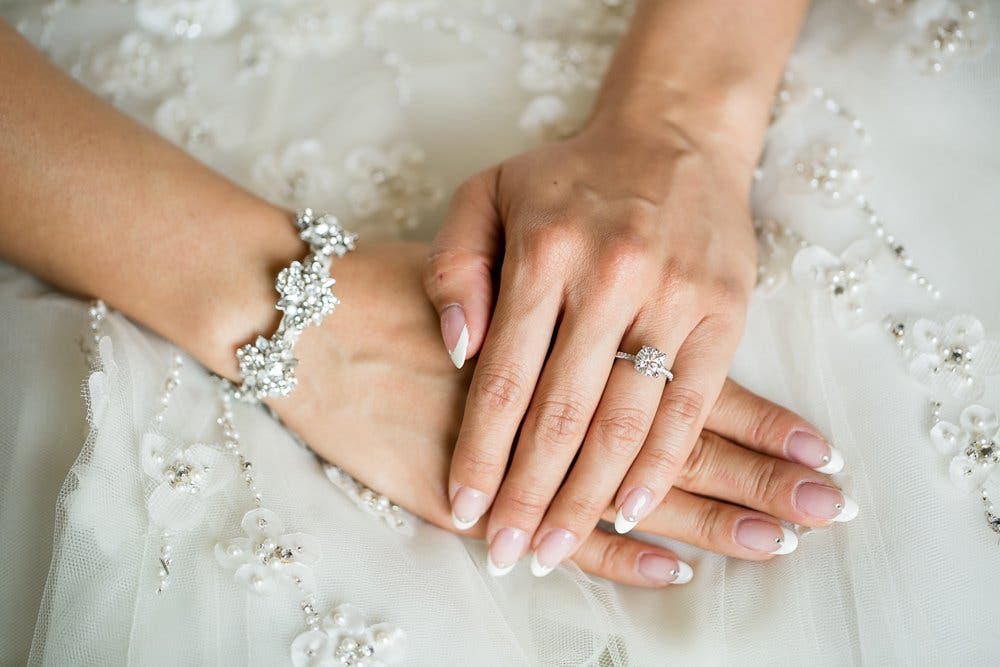 bride wears wedding rings