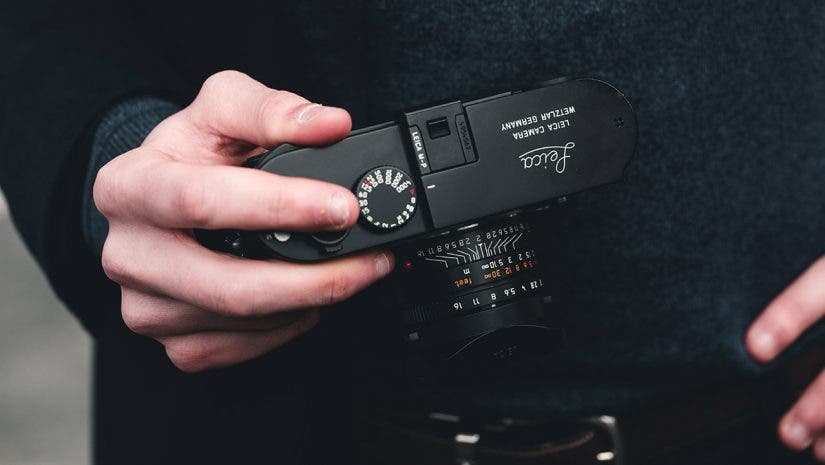 male photographer holding leica camera for beginners