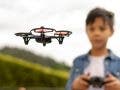young boy flying a drone