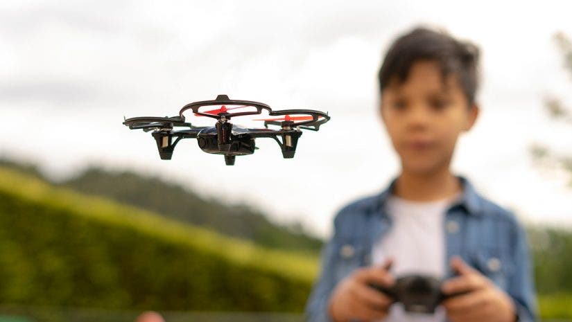 young boy flying a drone