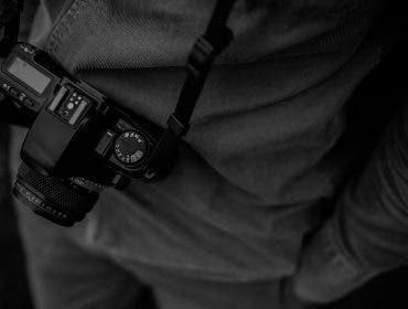 famous photographers with camera on strap