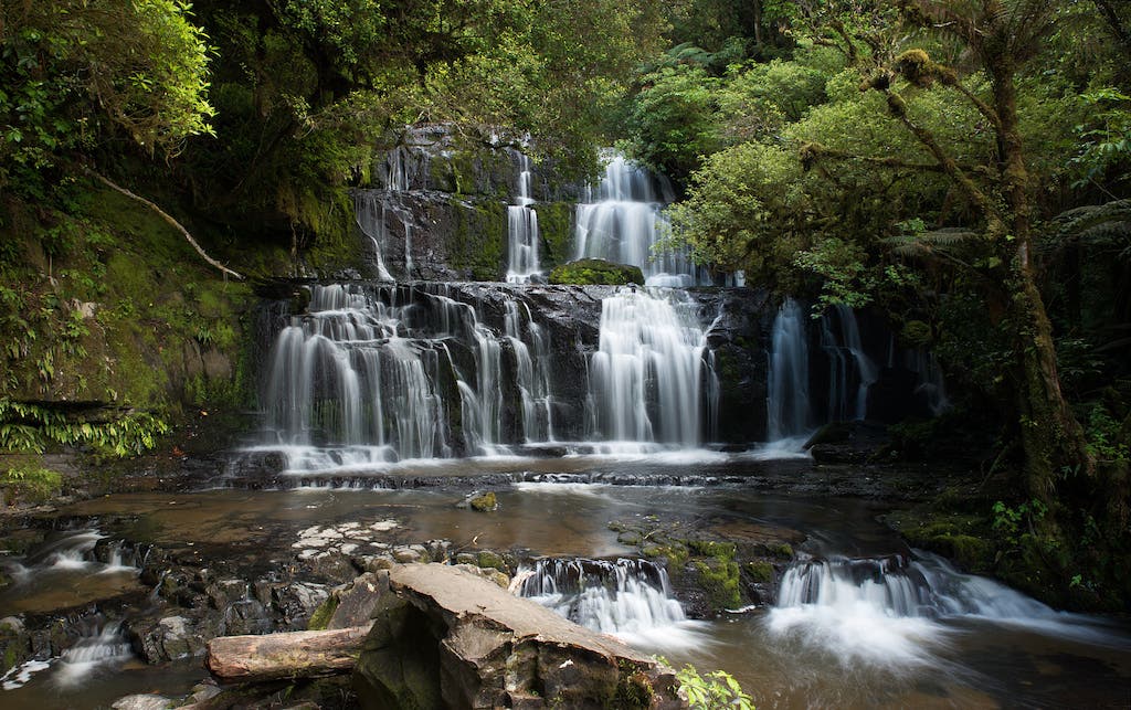 Small waterfall with water splashing and tumbling over the rocks