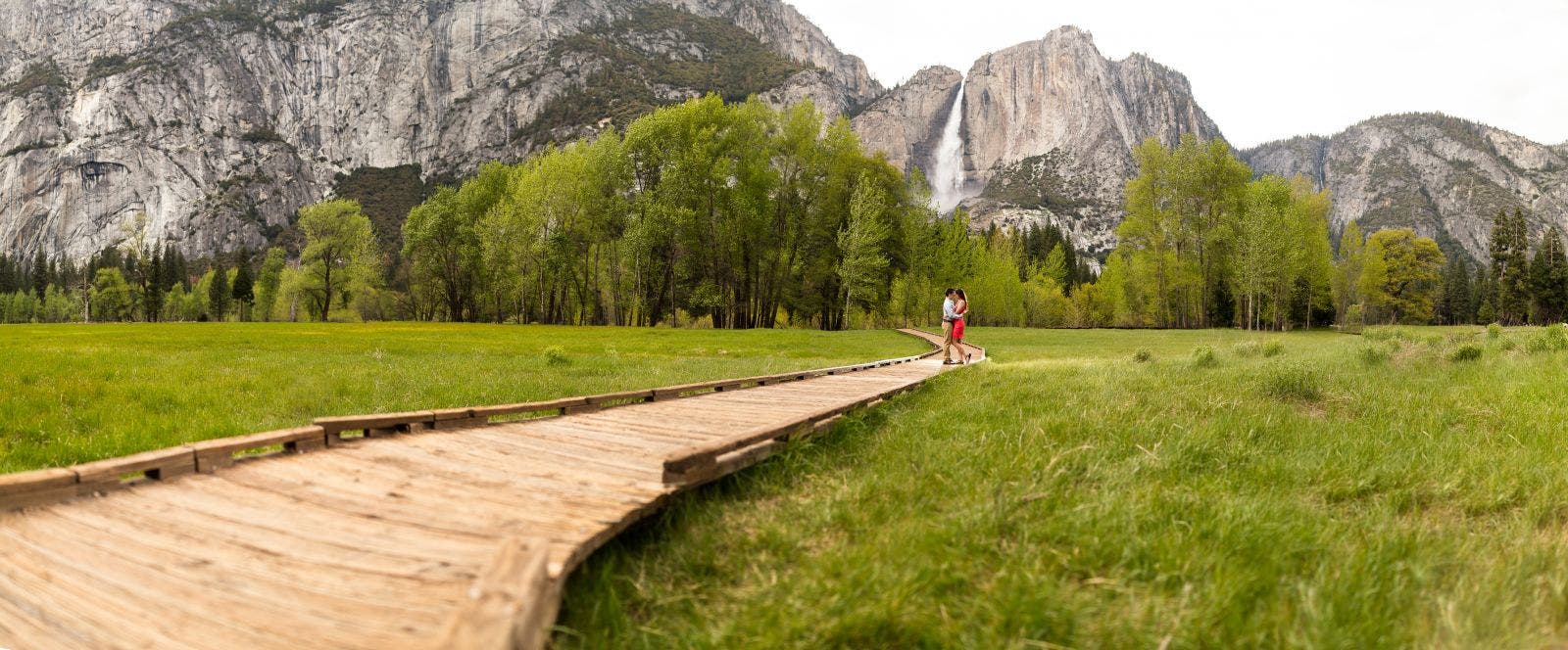 couple stands in front of yosemite
