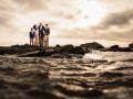 family at beach with water in foreground