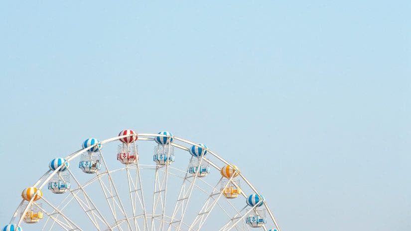 ferris wheel against blue sky negative space photography