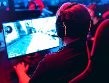 esports player at computer with monitor
