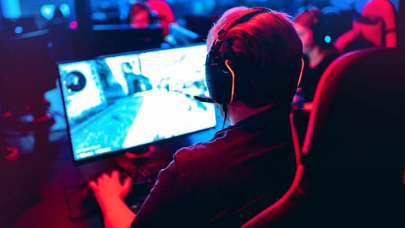 esports player at computer with monitor