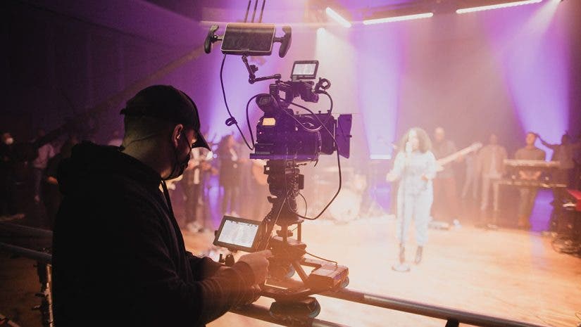 church of the highlands filmmaker capturing video footage with camera of performer