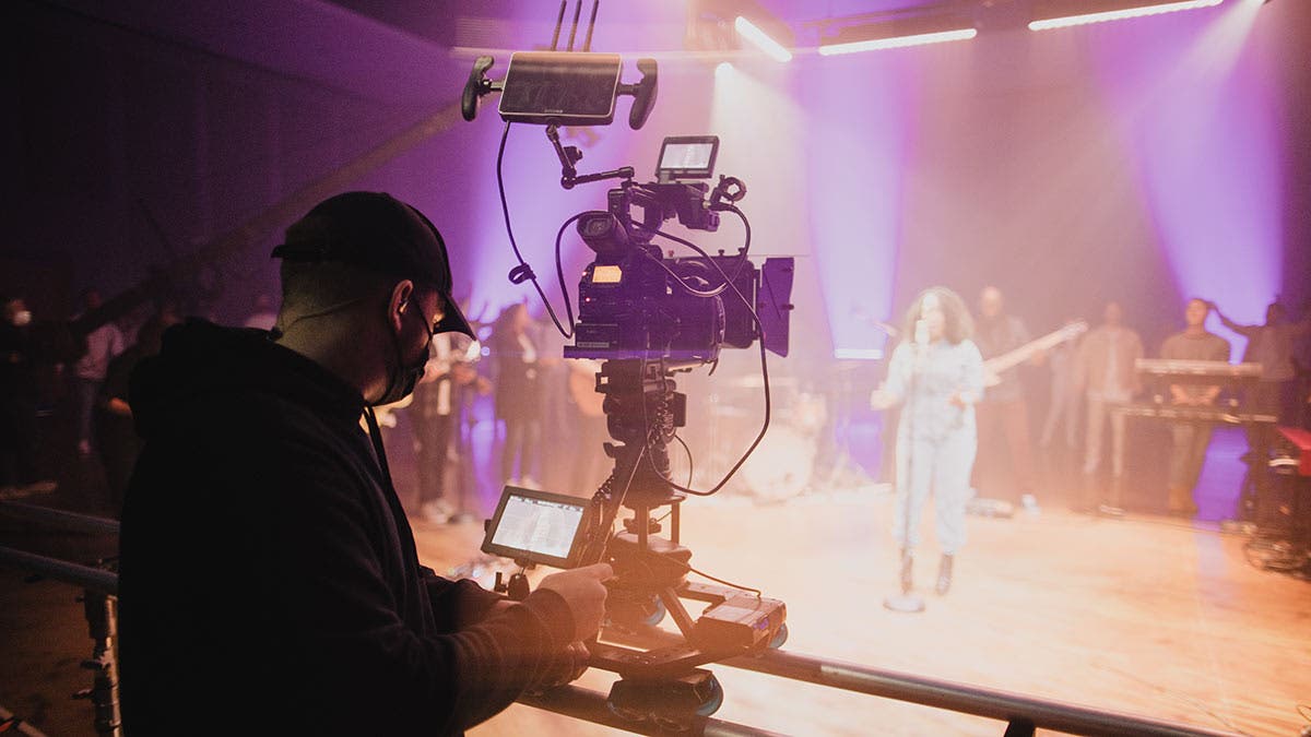 church of the highlands filmmaker capturing video footage with camera of performer