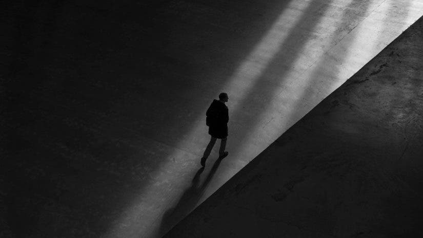 Man walking in shadows