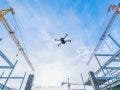 surveying drone flying above construction site