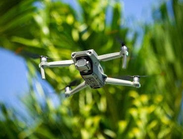 dji air 2s drone flying by palm trees
