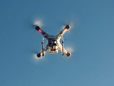 drone flying upward in sky