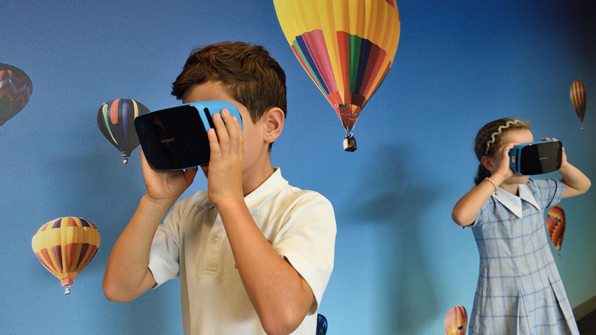 two young students using virtual reality headsets in school