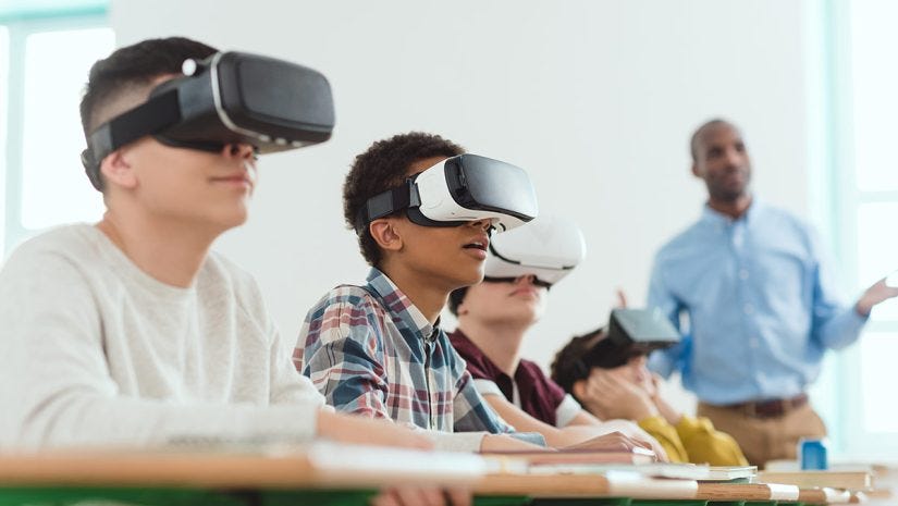 teacher and students in classroom education setting using virtual reality headsets