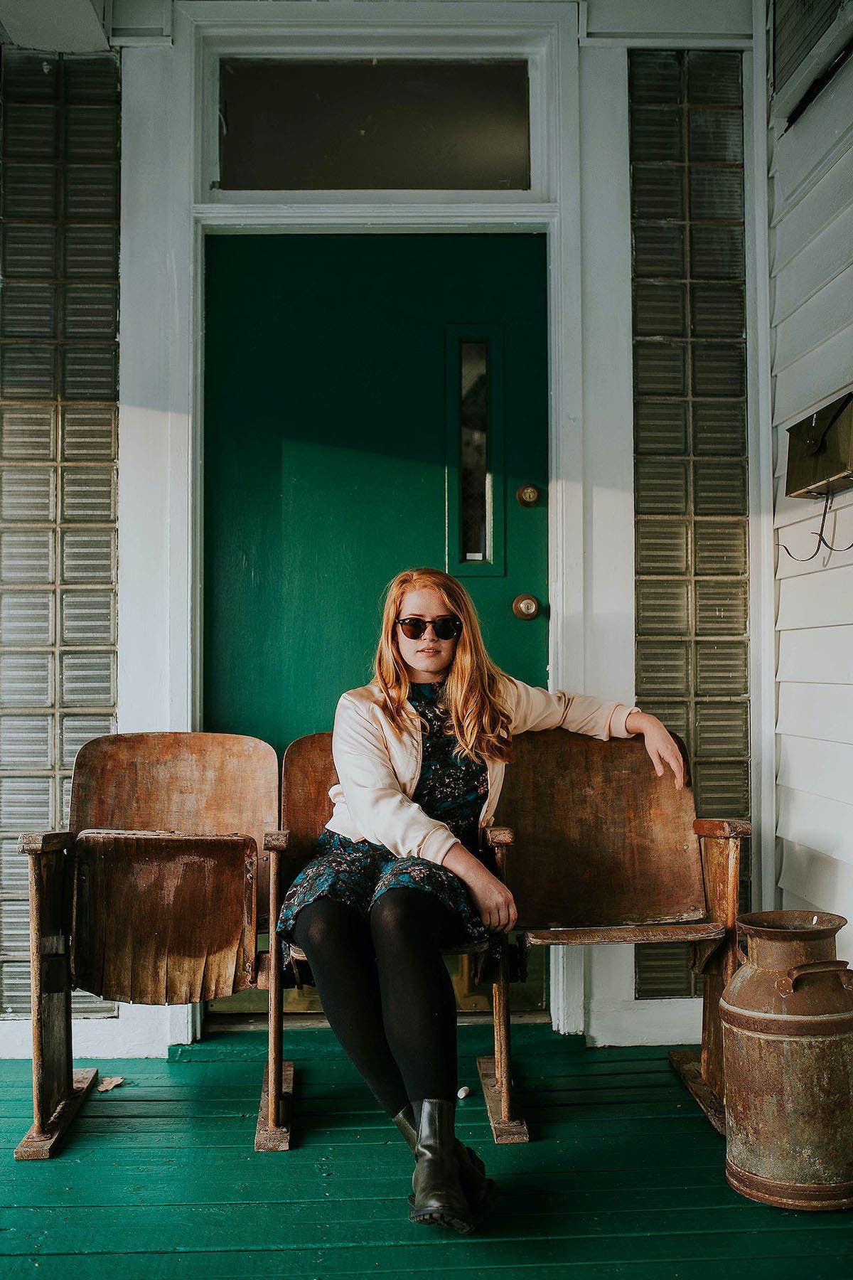 Portrait of a smiling woman sitting and posing on a chair over a gray  background Royalty-Free Stock Image - Storyblocks