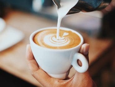 milk poured into coffee cup