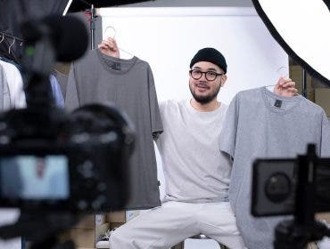 Young attractive Asian man blogger or vlogger looking at camera reviewing product. Modern businessman using social media for marketing. Business online influencer on social media concept.