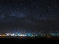 Panoramic view of the starry night sky above the city.