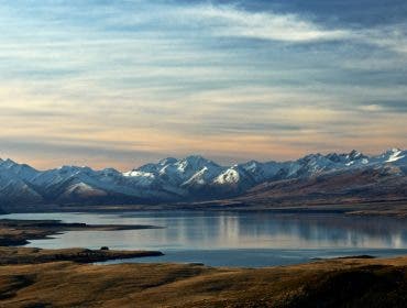 Lake Tekapo New Zealand with snowy mountains in the background.