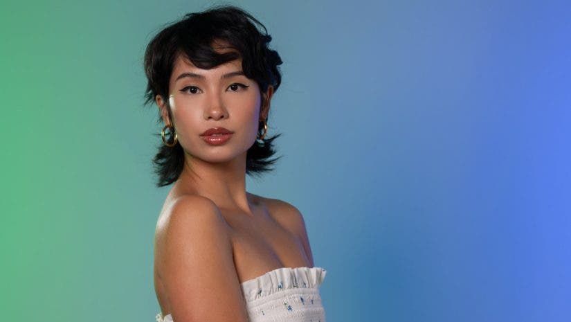 Female model in front of a blue green background lit evenly with flash and V-Flats