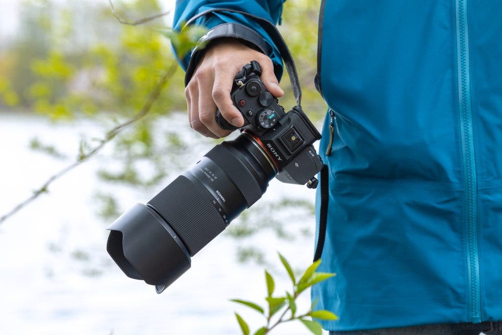 nature photographer holding new TAMRON lens