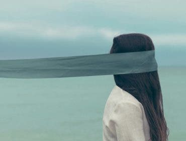 Portrait of a woman with a scarf, the scarf seems to blend into the horizon - the effect is surreal