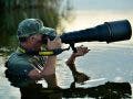 Wildlife photographer holding one of the best lenses for wildlife photography