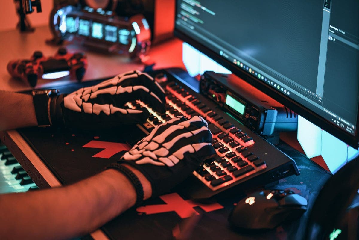 Man uses gaming keyboard with skeleton gloves