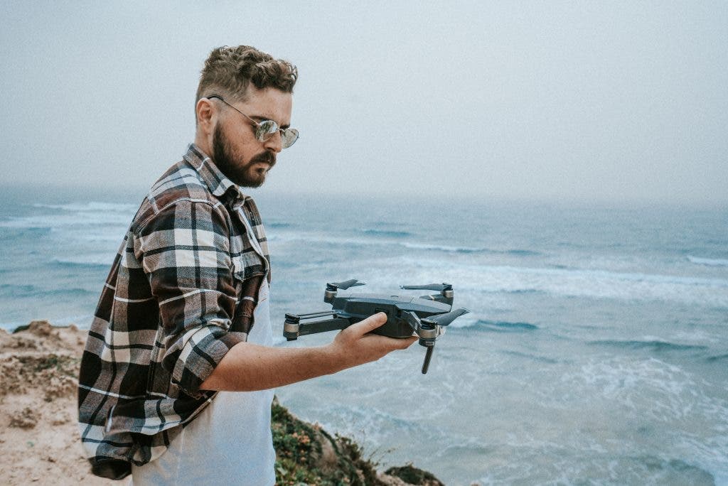 drone photographer holds his drone