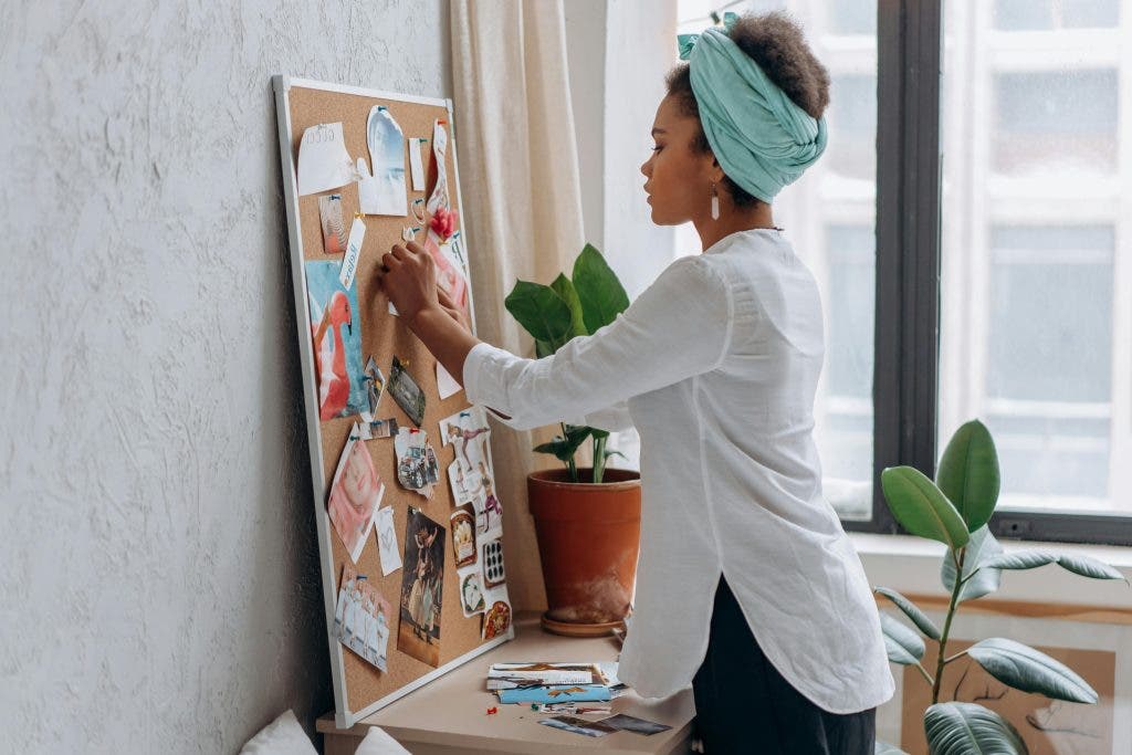a woman sets up a mood board